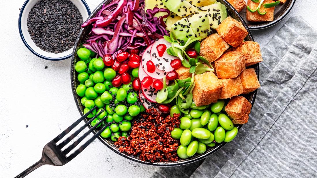 Buddha bowl with tofu and edamame and other veggies and seeds