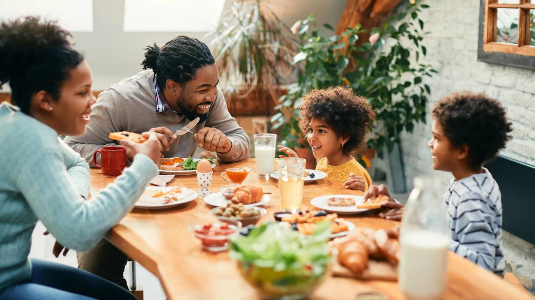 Happy family eating a meal together at table