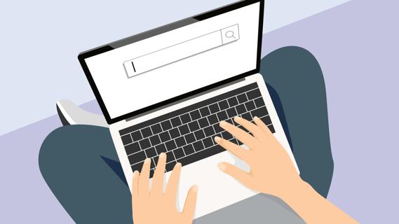 Laptop on person's lap, with fingers poised to type in the search bar
