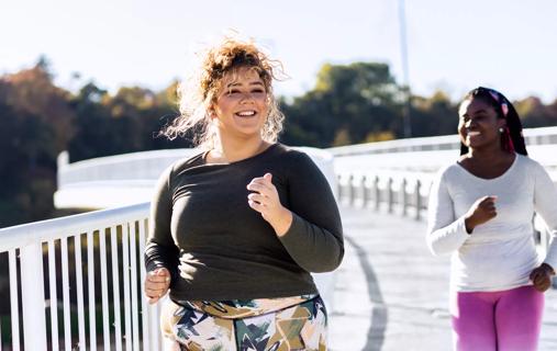 Female and friend jogging outside