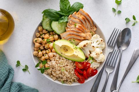Lean protein bowl with grains, chicken, chickpeas, cucumber, cauliflower, avocado and tomatoes