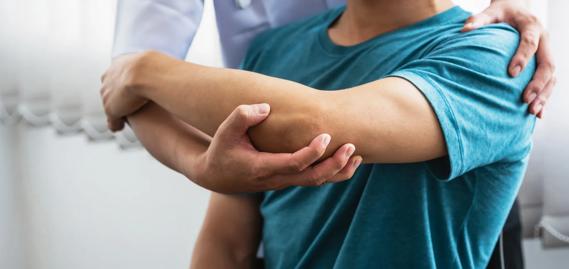 Physical therapist working with a patient with their arm
